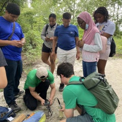 Learn how to use scientific equipment. Here the group got to use a YSI water quality meter.